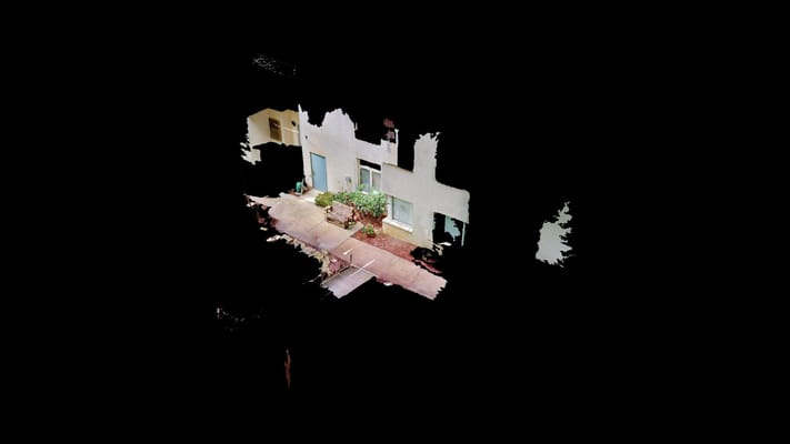 View of the courtyard with plants and seating area at Saint Anne's Terrace.