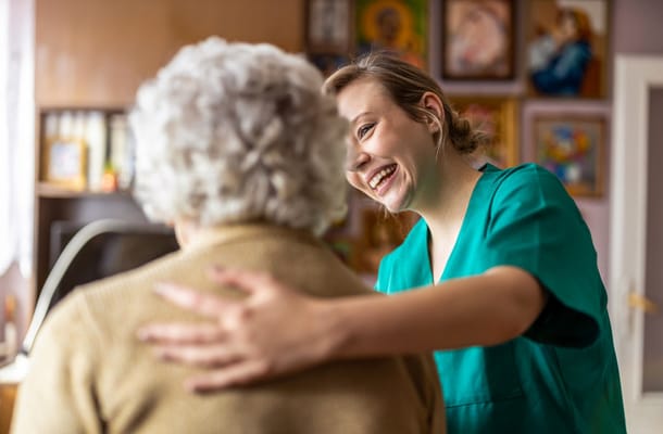 A staff member interacting with a resident in a warm setting