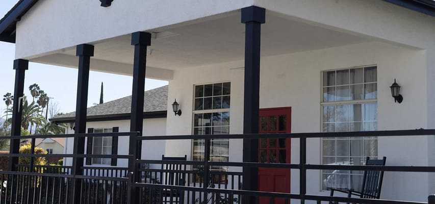Exterior view of a facility entrance with a red door