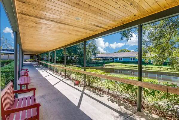 Covered walkway with seating and greenery
