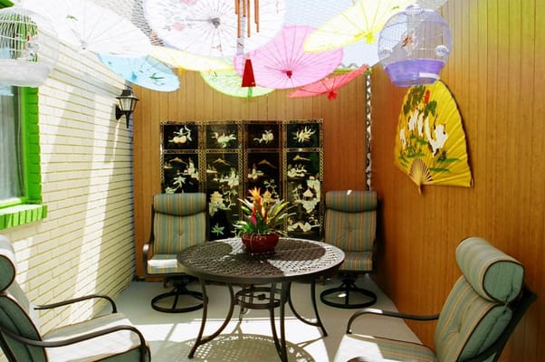 Colorful outdoor seating area with umbrellas and decor