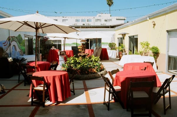 Outdoor dining area with tables and umbrellas