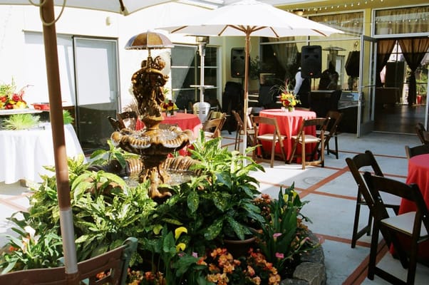 Outdoor courtyard with fountain and dining tables