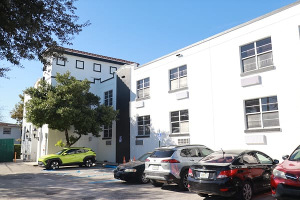 Exterior view of Floridean Nursing and Rehabilitation Center with vehicles