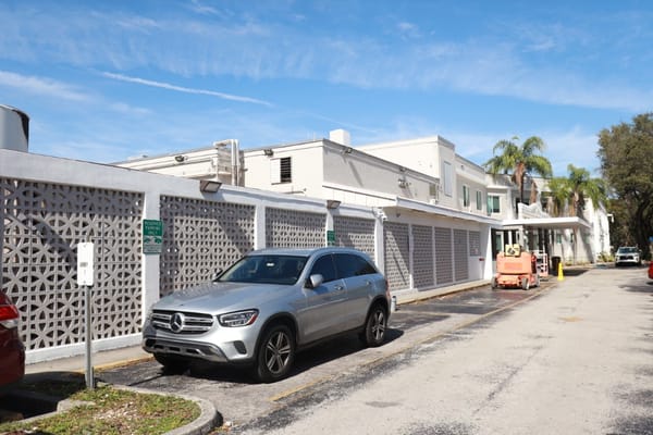 Exterior view of Jackson Memorial Long-Term Care Center with vehicle