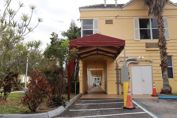 Entrance with a canopy leading to the facility