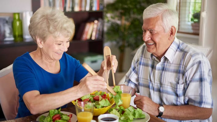 Two residents enjoying a salad meal together