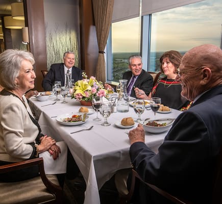 Residents enjoying a meal at a dining table
