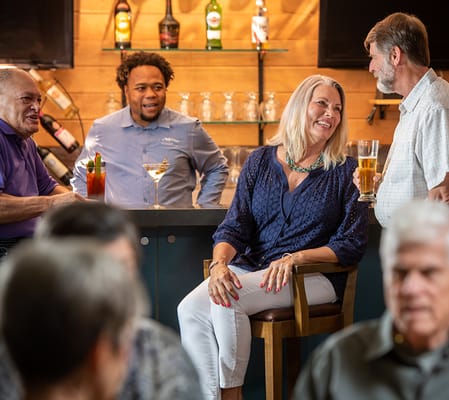 Residents enjoying drinks and socializing in a common area