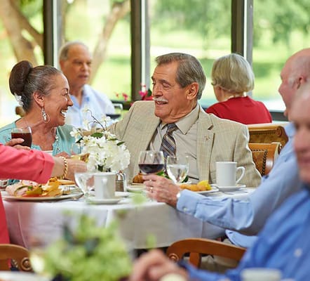 Residents enjoying a meal together in the dining room
