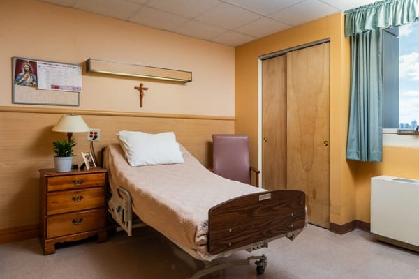 Private resident room with a bed and a chair