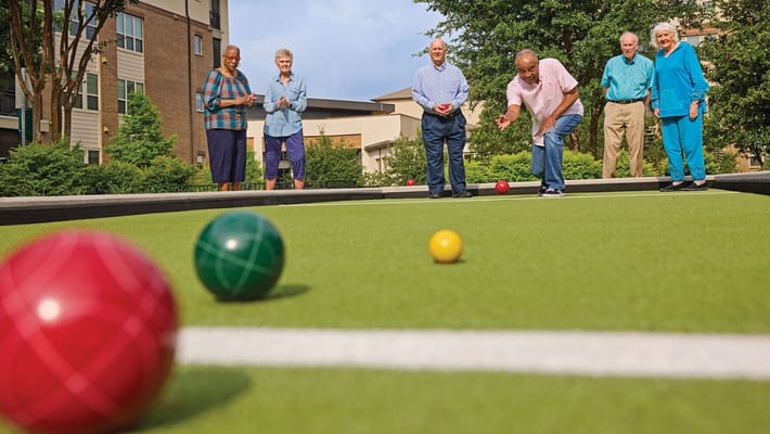 Residents enjoying a game of bocce ball outdoors