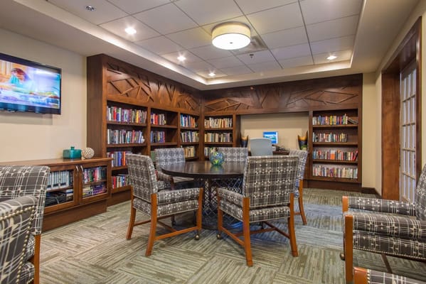 Interior view of a cozy library area with seating and bookshelves