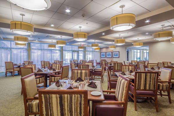 Elegant dining area with tables and chairs set for a meal