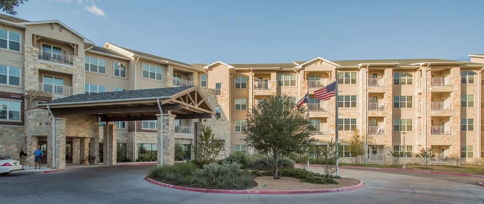Exterior view of a senior living facility with flags