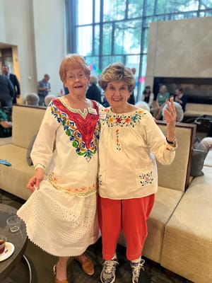 Two residents in traditional attire celebrating an event