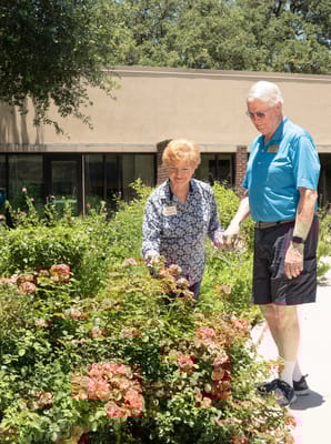 Two residents enjoying flowers in the garden