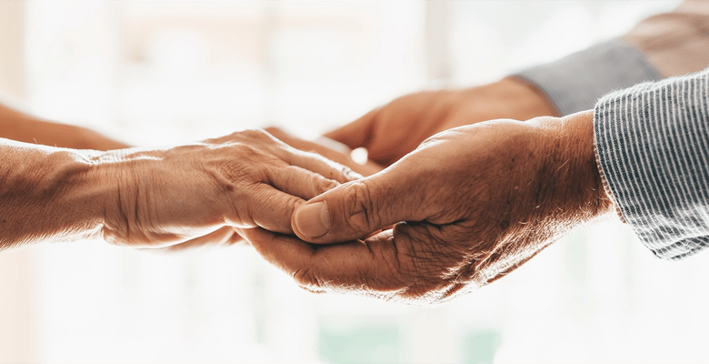 Close-up of two hands holding each other