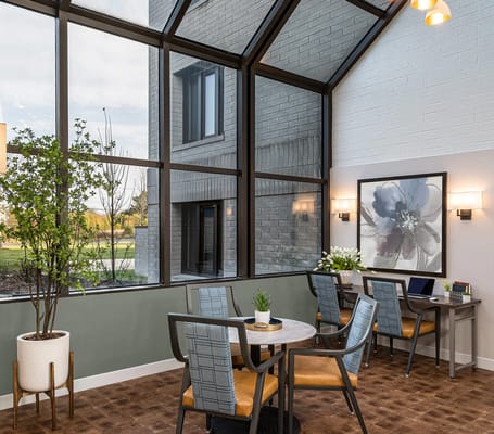 Bright common area with large windows and seating