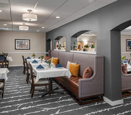 Bright dining room with tables and booths set for dining