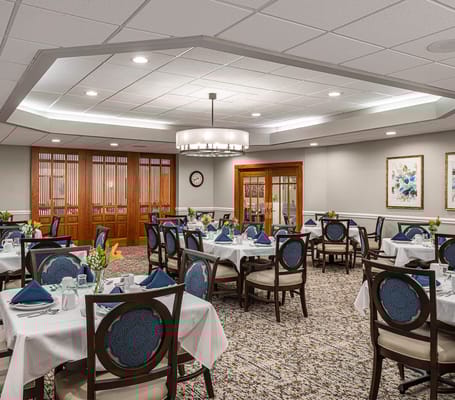 Elegant dining room with round tables and floral centerpieces