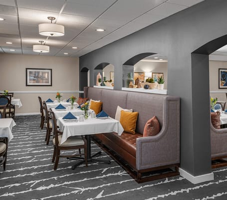 Dining room with elegantly set tables and comfortable seating