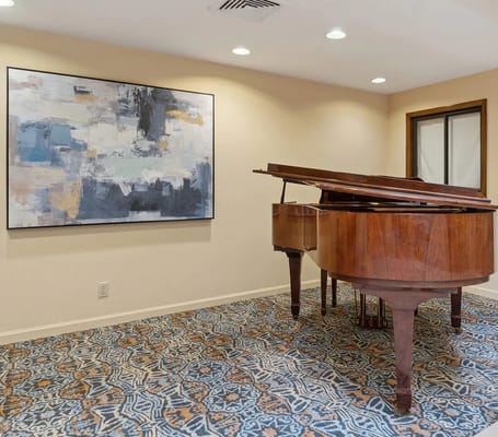 Interior view of a room with a piano and art