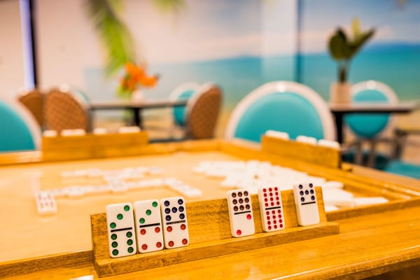 Residents playing dominoes in a lounge area