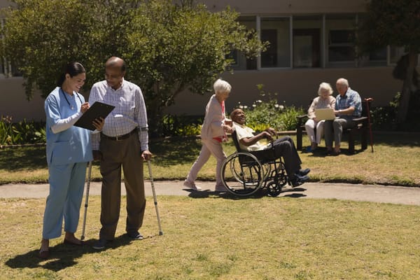 Residents and staff in an outdoor garden area