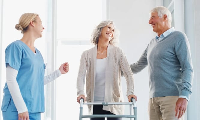 Three individuals smiling in a bright facility setting