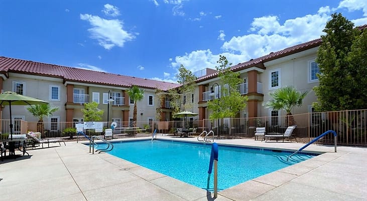 Outdoor swimming pool area surrounded by facility buildings