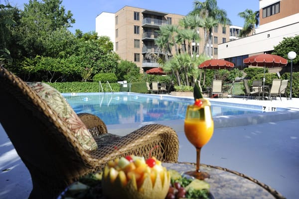 Poolside view with tropical landscaping and fruit display