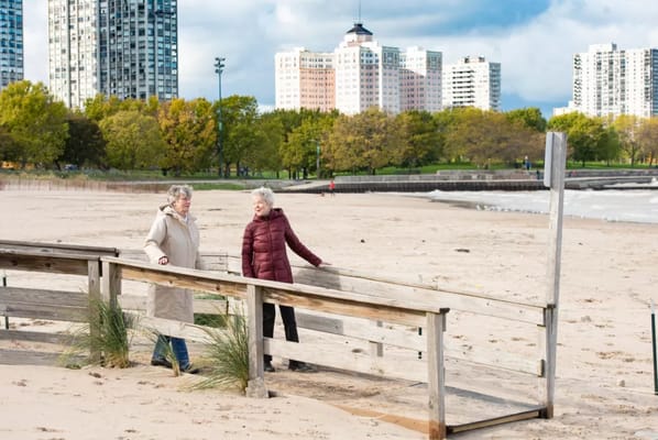 Two women enjoying a beachside walk