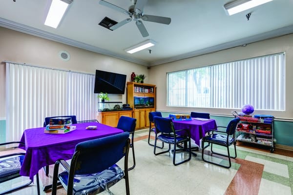 Interior activity room with tables and chairs