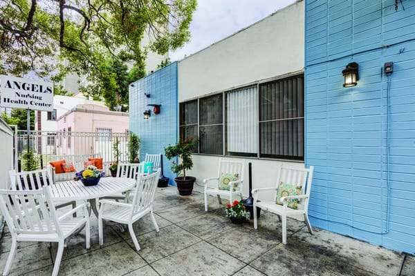 Outdoor seating area with tables and flowers