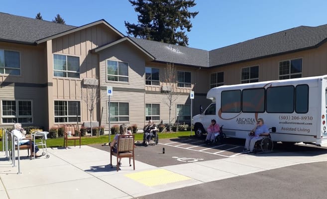 Residents enjoying outdoor space in front of the facility