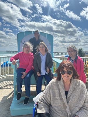 Residents enjoying a sunny outdoor space by the coast