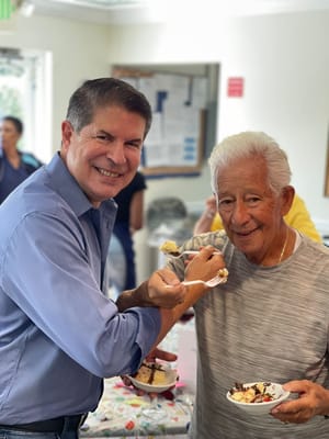 Residents enjoying cake in a common area