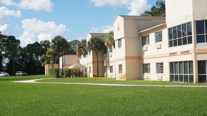 Exterior view of the facility building with landscaped grounds