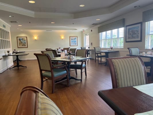 Dining area with tables and chairs in a bright room