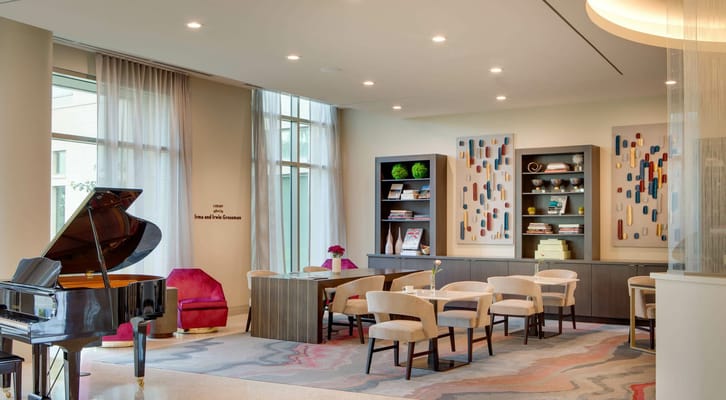 Elegant library area with a grand piano and seating