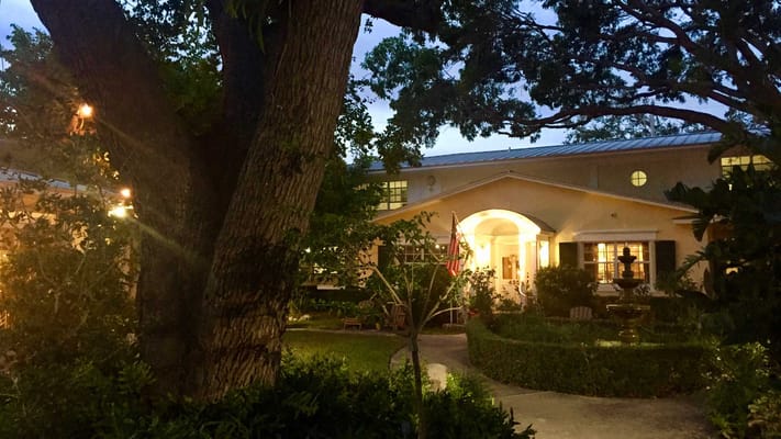Exterior view of Bay Oaks Historic Retirement Residence at night