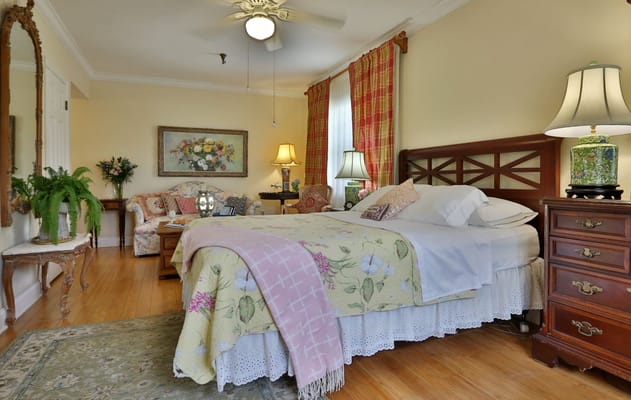 A cozy resident room with floral decor and bright lighting