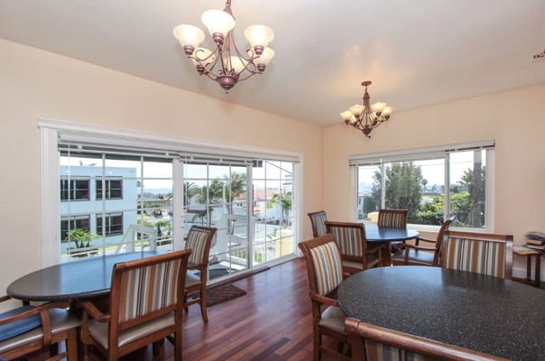 Bright dining room with wooden tables and chandeliers