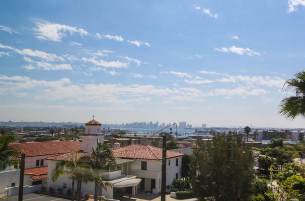 View of a senior living facility with a city skyline in the background