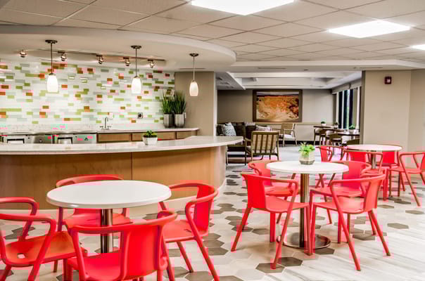 Bright and modern common area with seating and tables