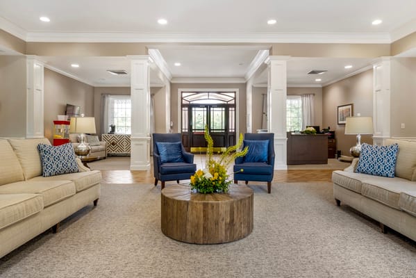 Cozy living room with seating and floral centerpiece.