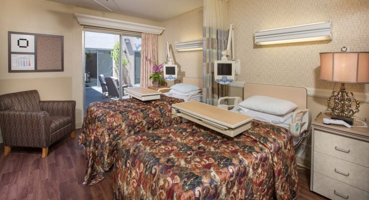 A shared resident room with two beds and a window