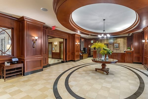 Elegant lobby interior with wooden finishes and floral arrangement