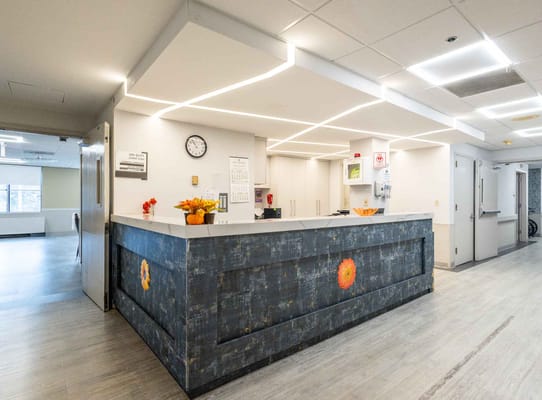 Modern reception area with floral decorations and a front desk